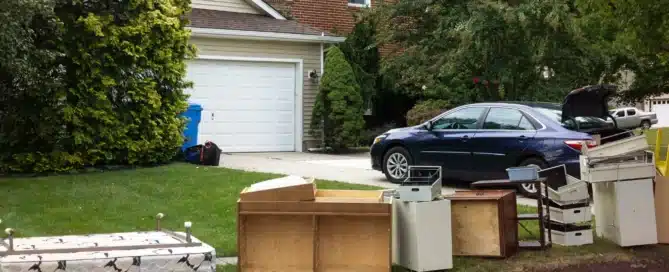 Junk removal crew loading furniture, appliances, and household waste into a truck during same-day pickup service in New York